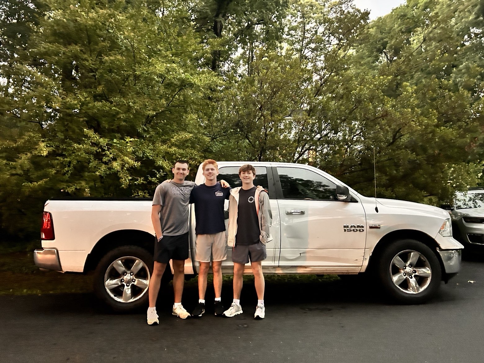 Sam Whipple, Owen Murdock, and Andy Mustico — founders of River Road Junk Removal — standing in front of their work truck